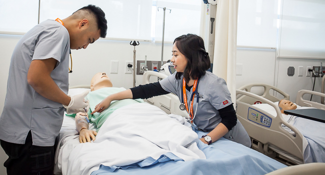 two students working in a nursing simulation lab at Langara College